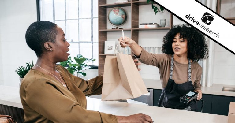 a woman purchasing items from a store cashier experiencing a customer touchpoint