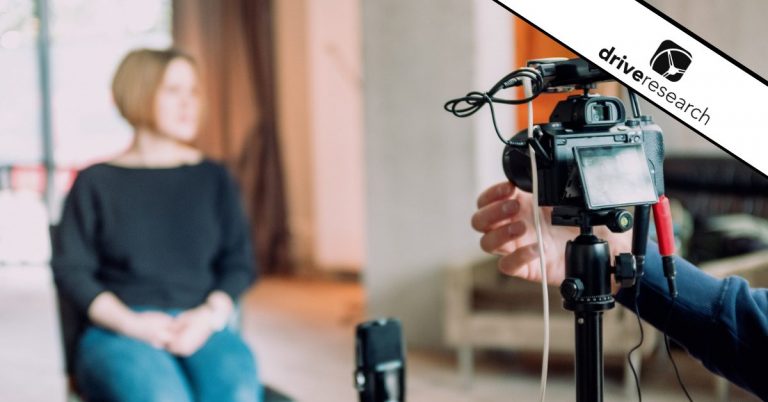 a camera and mic showing a home interview with a woman