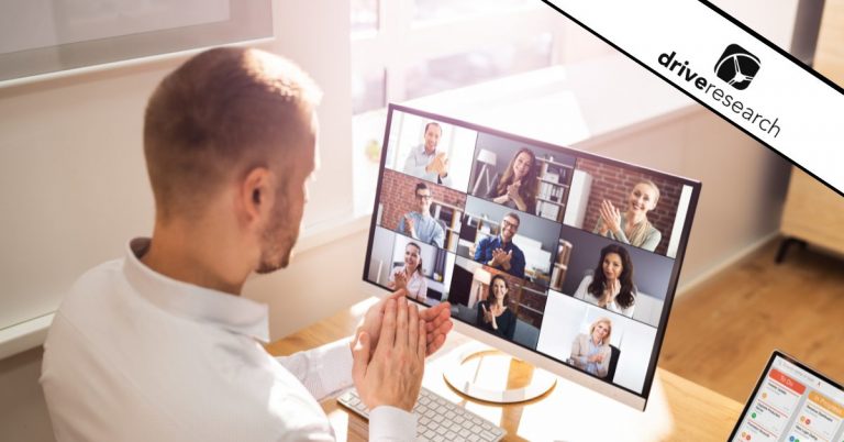 a man looking at his computer showing a large web interview happening