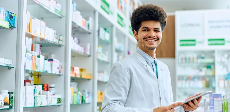 Male pharmacist behind counter