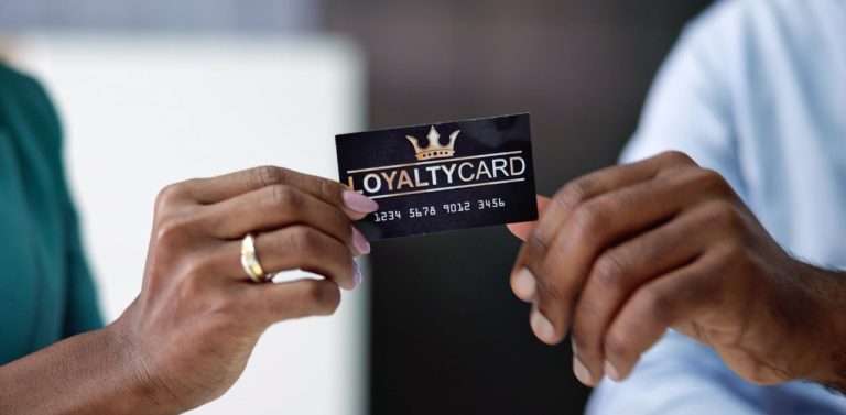 Hands holding loyalty cards