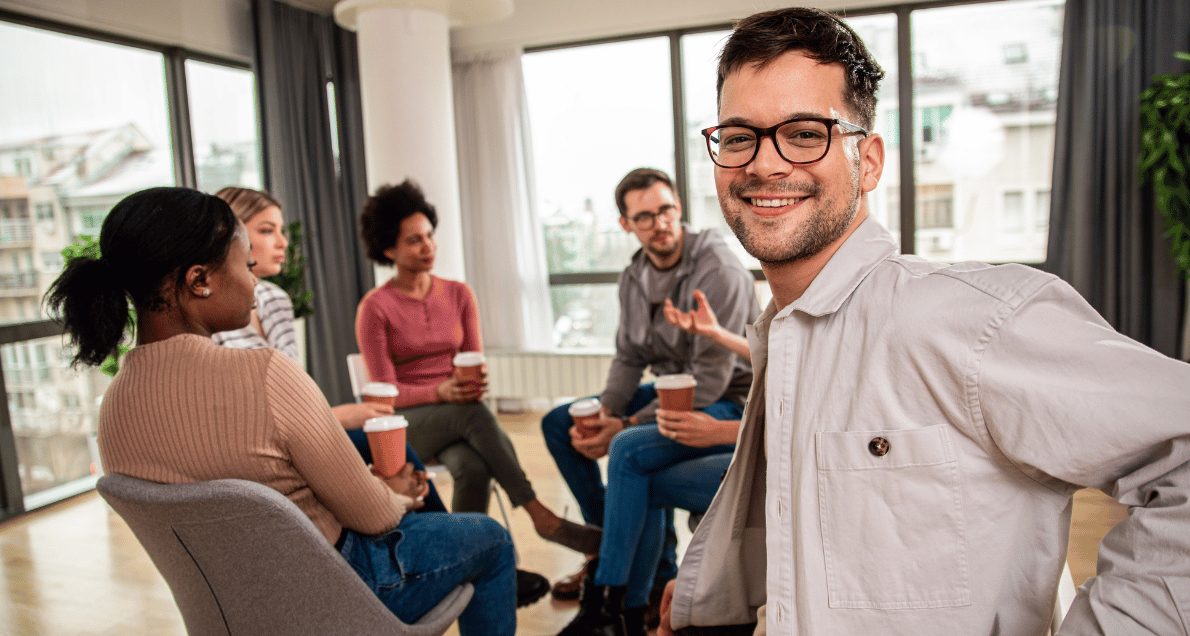 Focus group with diverse people sitting in chairs in a circle