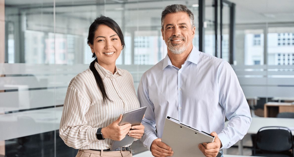 Happy business man and woman in office