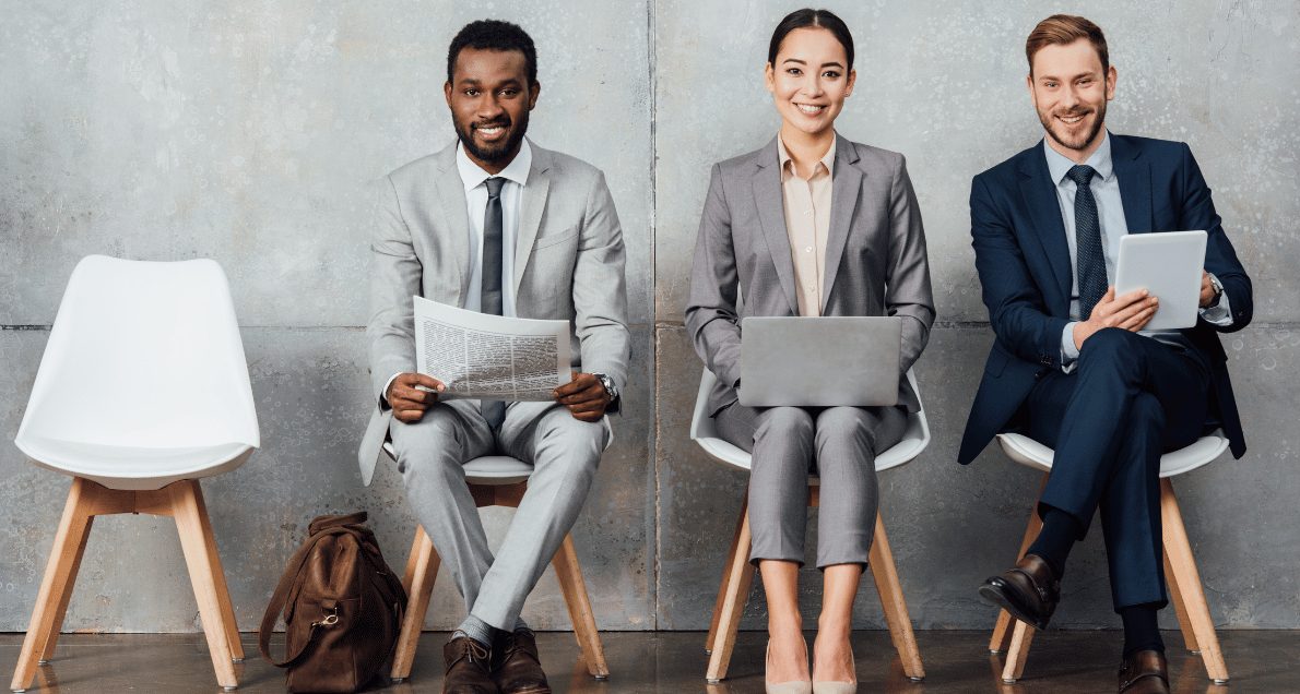 Smiling business people sitting in chairs