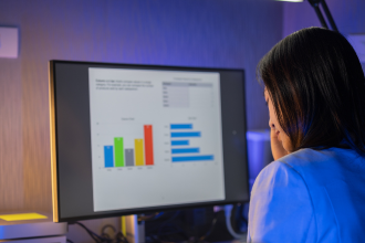 Back view of female taking a UX survey on her computer