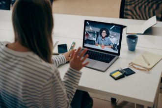 Back view of female waving to UX research during video moderated interview