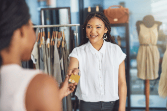 Cashier taking a credit card payment from loyal customer