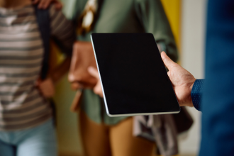 Close up image of person holding tablet