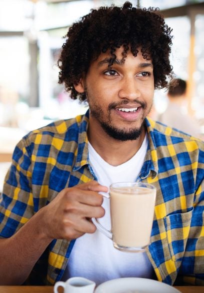 Handsome black male drinking coffee