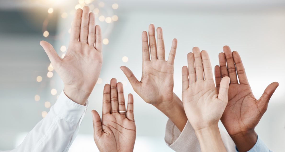 Diverse hands being raised