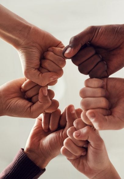 Diverse hands in team huddle