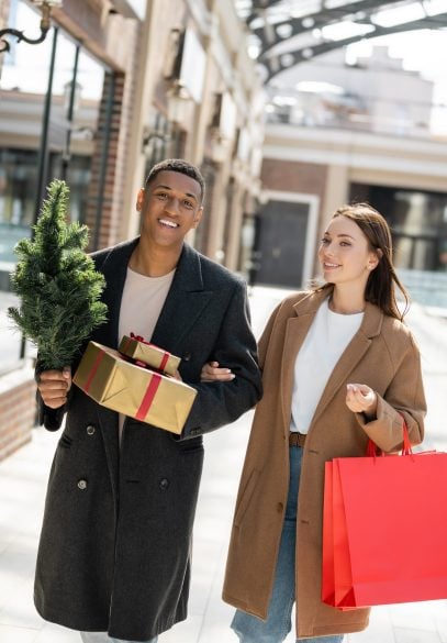 Happy couple holiday shopping in a mall