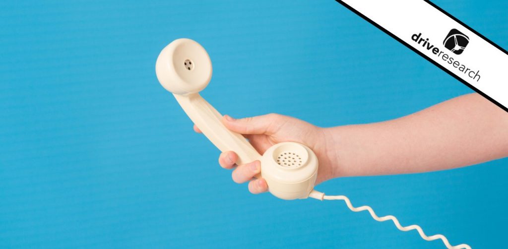 Holding a telephone being used for surveys or interviews