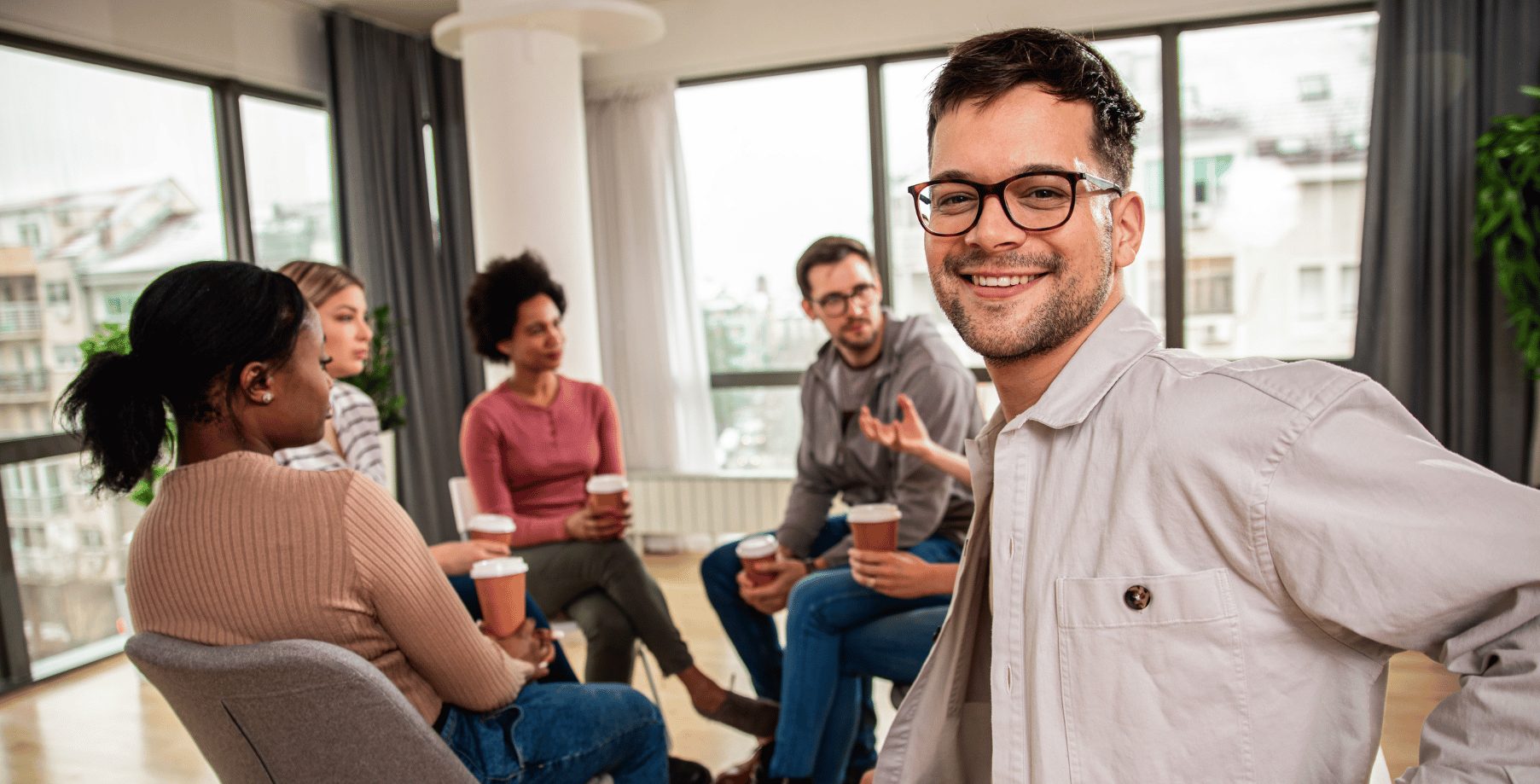 Man with glasses sitting and participating in market research study