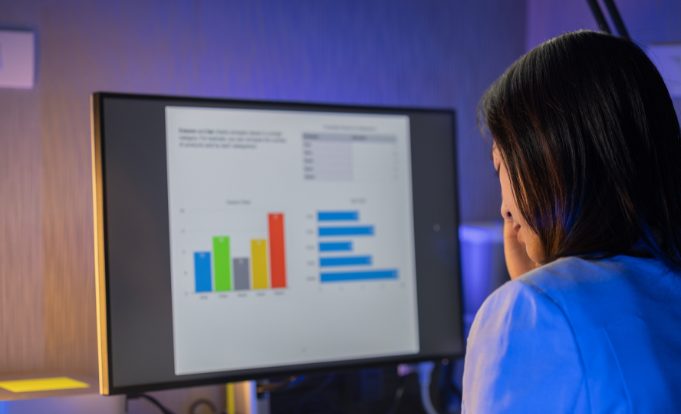 Woman looking at market survey results on a computer