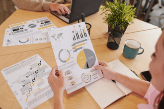 Woman looking at quantitative market research report on paper