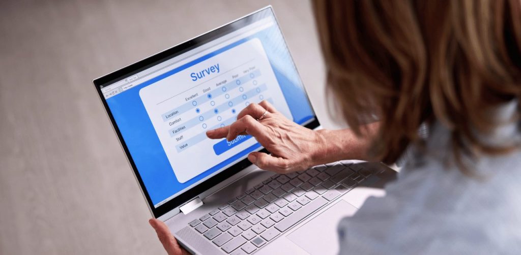 Woman taking an online survey on laptop