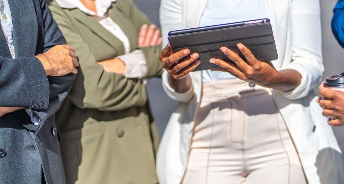 Women conducting intercept survey with tablet outside