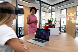 Young professionals using VR goggles in the office