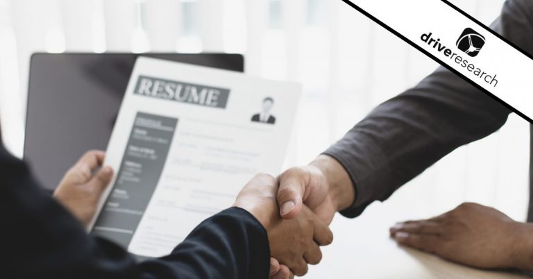 a job interview showing candidates shaking hands while using market research