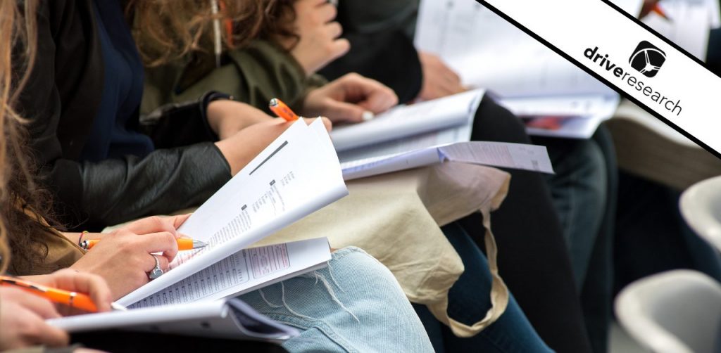 a picture showing students and graduates in class taking a survey