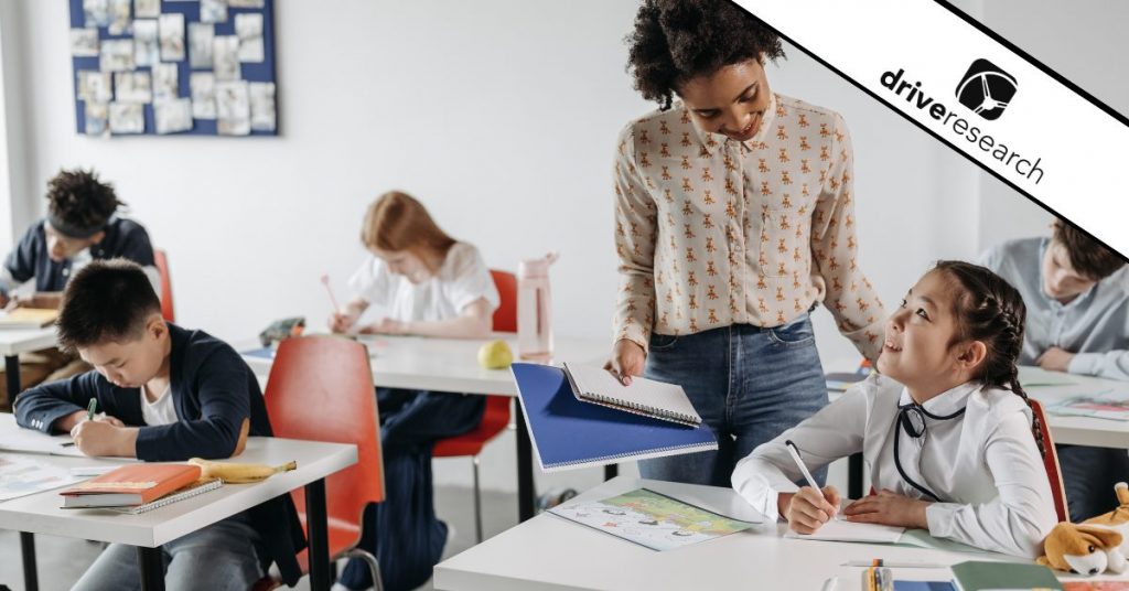 Teacher speaking with student in class