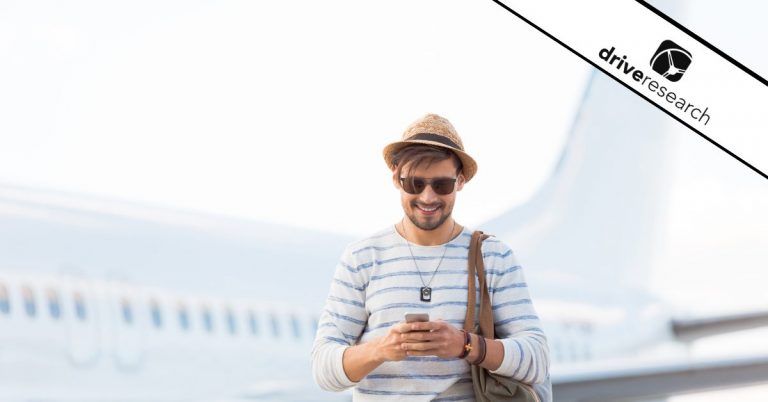 Male traveler on phone in front of airplane