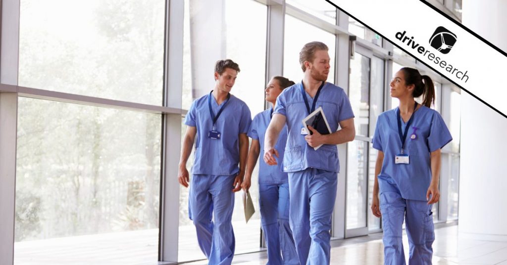 Physicians walking down hallway in hospital