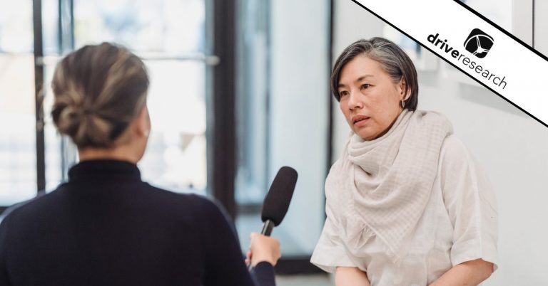 a person interviewing with a microphone showing an event survey