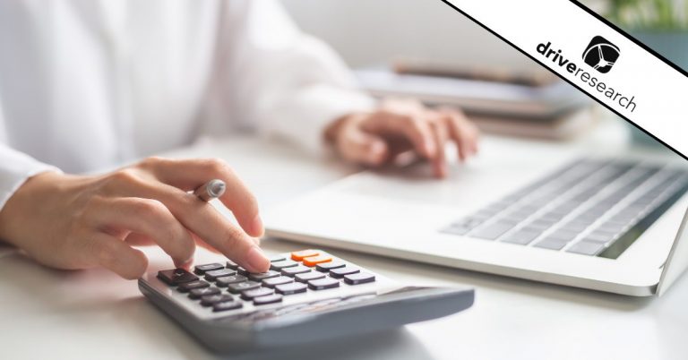 a woman typing on a calculator to find a cost estimate for market research