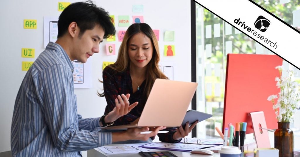 two people working on computers showing how a user experience interview is done