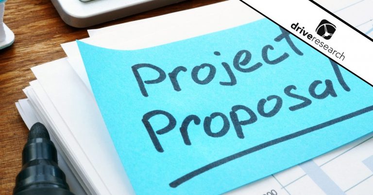 Project proposal written on a blue sticky note