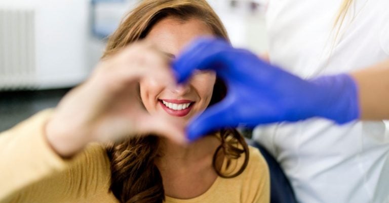 Patient and doctor making a heart with their hands