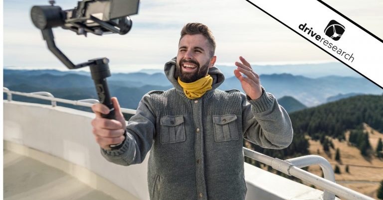 Male influencer filming content on mountain