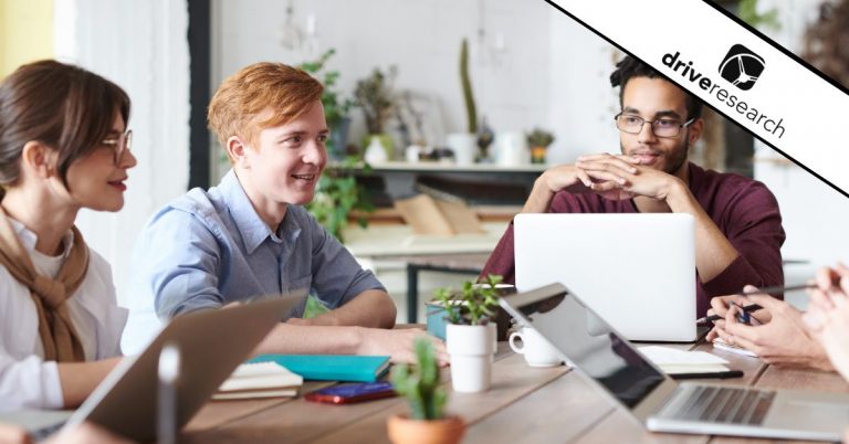 Employees working and talking around a work conference table