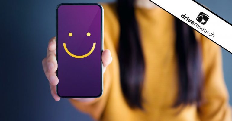 Holding phone with smiling face on screen