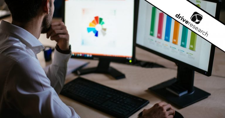 Man looking at screen with charts on it