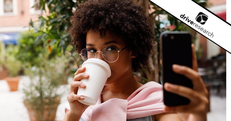 Female influencer taking a picture while drinking coffee