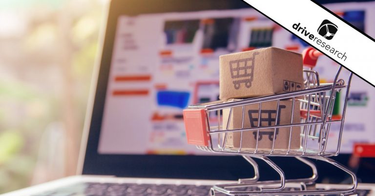 Shopping cart with boxes in front of a computer