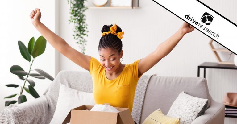 Woman in yellow shirt cheering opening a package