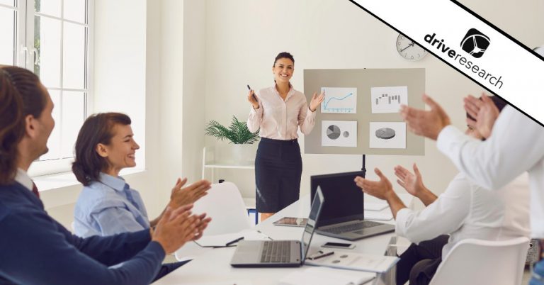 Female presenting charts at a meeting - Drive Research