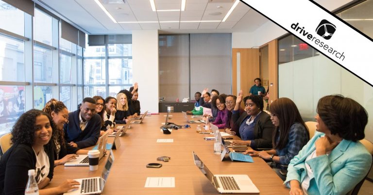 Employees sitting in a board room talking