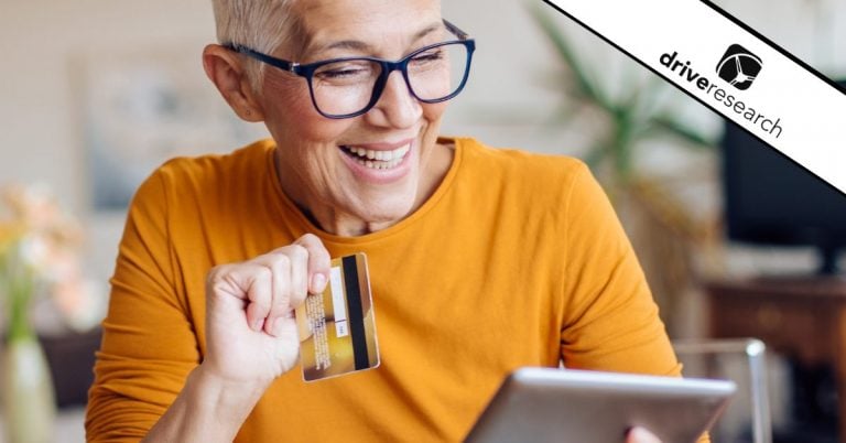 Older female with glasses buying something with a credit card