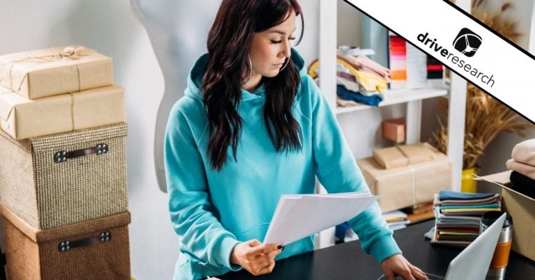 Woman in blue sweatshirt in retail store on computer