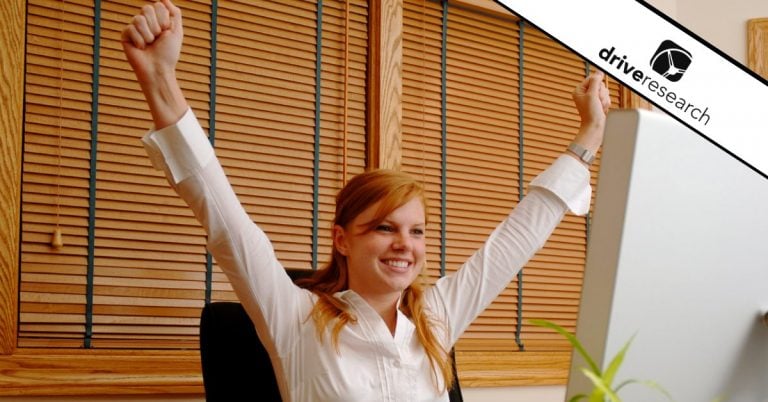 Female employee cheering at desk