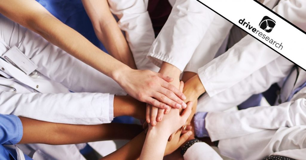 Doctors putting their hands in a circle