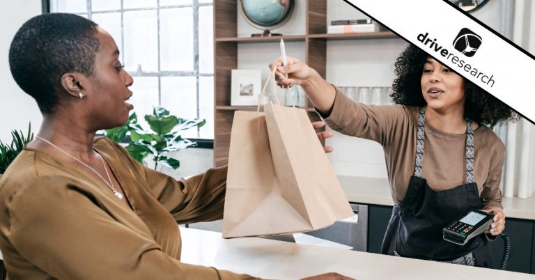 Female business owner handing over a bag to a customer