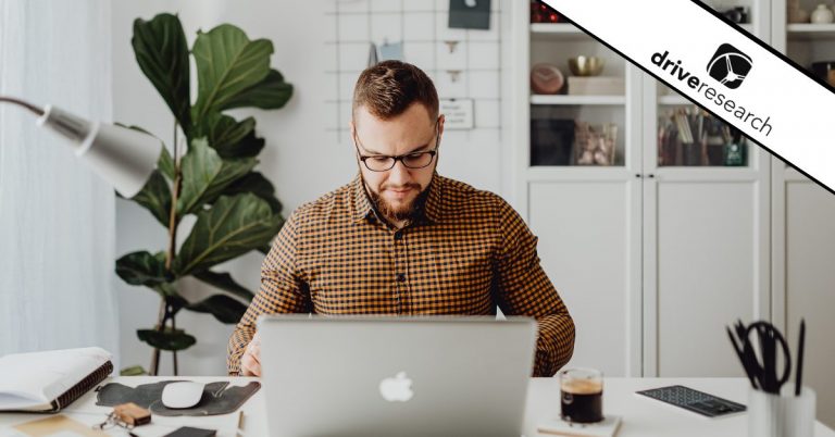 Man with glasses and plaid shirt working at home office