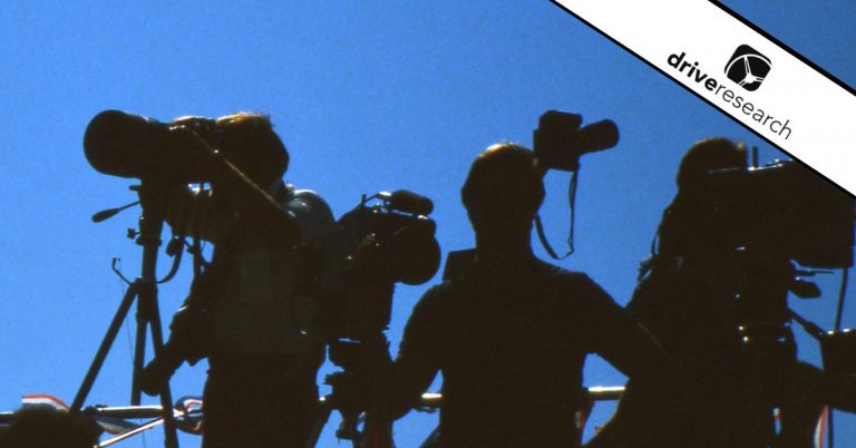 Film crew in front of blue background