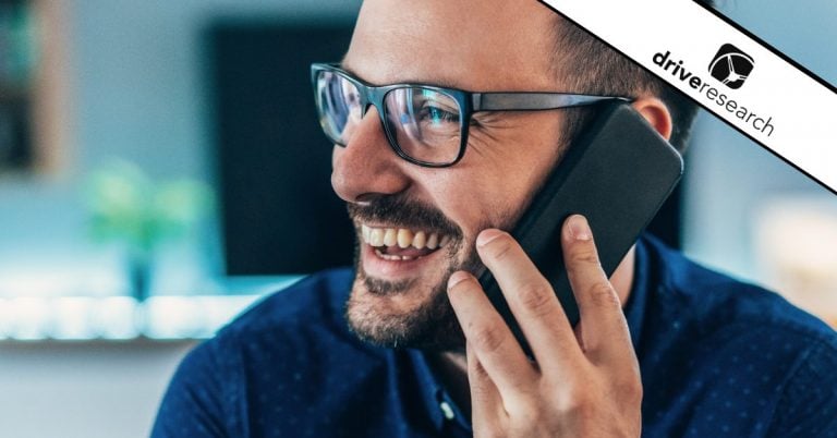 Male with glasses smiling on cell phone